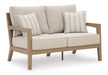 Hallow Creek Outdoor Loveseat with Cushion - World Furniture Gallery (Newark, CA)